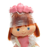 Dancin' Strawberry Shortcake doll with plastic wrap on hair and pink headband