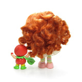 Back of Strawberry Shortcake Berrykin doll with Strawberrykin Critter