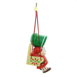 Girl in swing with green bonnet, red dress and white cat ornament