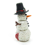 Snowman figurine with black hat and carrot nose