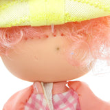 Peach Blush Strawberry Shortcake doll with brown spot on back of head
