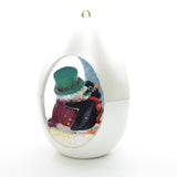 Penguins building snowman ornament