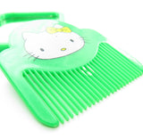 Hello Kitty green plastic comb with chips in plastic