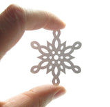 Snowflake paper punches with intricate cutouts