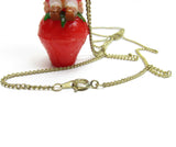 Gold clasp on Strawberry Shortcake pendant necklace