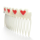 White hair comb with red hearts