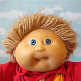 Cabbage Patch Kids boy doll with light brown hair, blue eyes, dimples, tooth