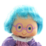 Plum Puddin doll with blue hair and purple glasses