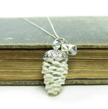 White snowy pine cone charm necklace on silver chain