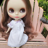 White Blythe doll nightgown with lace trim and purple ribbons