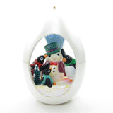 Penguins building snowman ornament