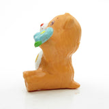 Side of Friend Bear sitting with a flower miniature figurine