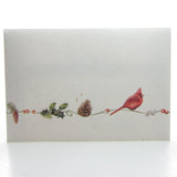 Envelope with pine cones, holly, and cardinal