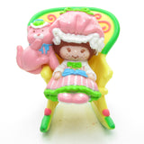 Strawberry Shortcake with Custard reading in a rocking chair miniature figurine