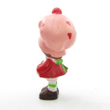 Strawberry Shortcake miniature figurine with three berries in apron