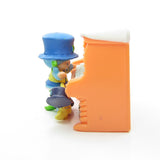 Side view of Blueberry Muffin with Cheesecake at the piano miniature figurine set