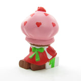 Strawberry Shortcake wrapping a gift or present miniature figurine