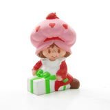 Strawberry Shortcake wrapping a gift or present miniature figurine