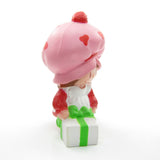 Strawberry Shortcake wrapping a gift or present miniature figurine