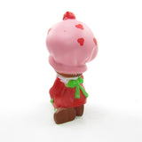 Strawberry Shortcake wrapping a gift or present miniature figurine