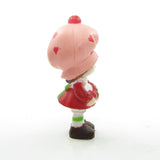 Strawberry Shortcake miniature figurine with three berries in apron