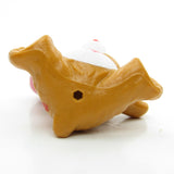 Bottom of Tenderheart Bear holding heart-shaped balloons figurine