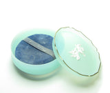 Vintage Avon Rapture powder container with doves