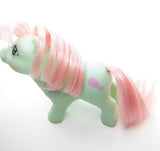 Baby Cuddles pony with pink rattle symbol
