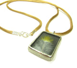 This bird lover's necklace features a real bird feather and is finished with a silver clasp.