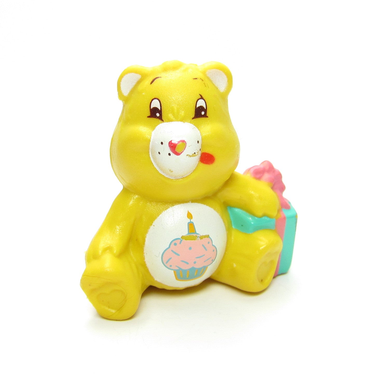 Birthday Bear sitting with a present figurine