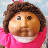 Cabbage Patch Kids girl doll with dark brown hair, brown eyes