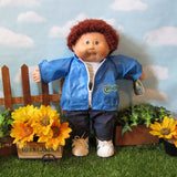 Cabbage Patch Kids boy doll with brown hair, brown eyes, tooth