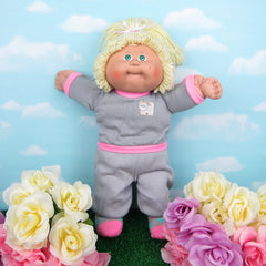 Cabbage Patch Kids girl doll with blonde hair, green eyes, tan skin