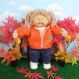 Cabbage Patch Kids girl doll with light brown hair, green eyes, dimples and tooth