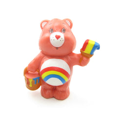 Cheer Bear painting a colorful rainbow Care Bears figurine