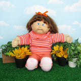 Cabbage Patch Kids Cornsilk doll with golden brown hair, blue eyes, tooth