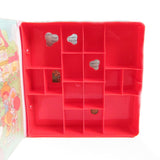 Inside compartments of Strawberry Shortcake Storybook Play Case
