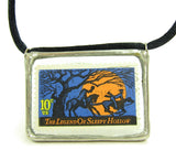 The Headless Horseman chases Ichabod Crane on this postage stamp pendant necklace.