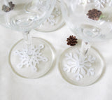These die cut paper snowflakes make a festive decoration for a winter party or wedding when placed under wine glasses.