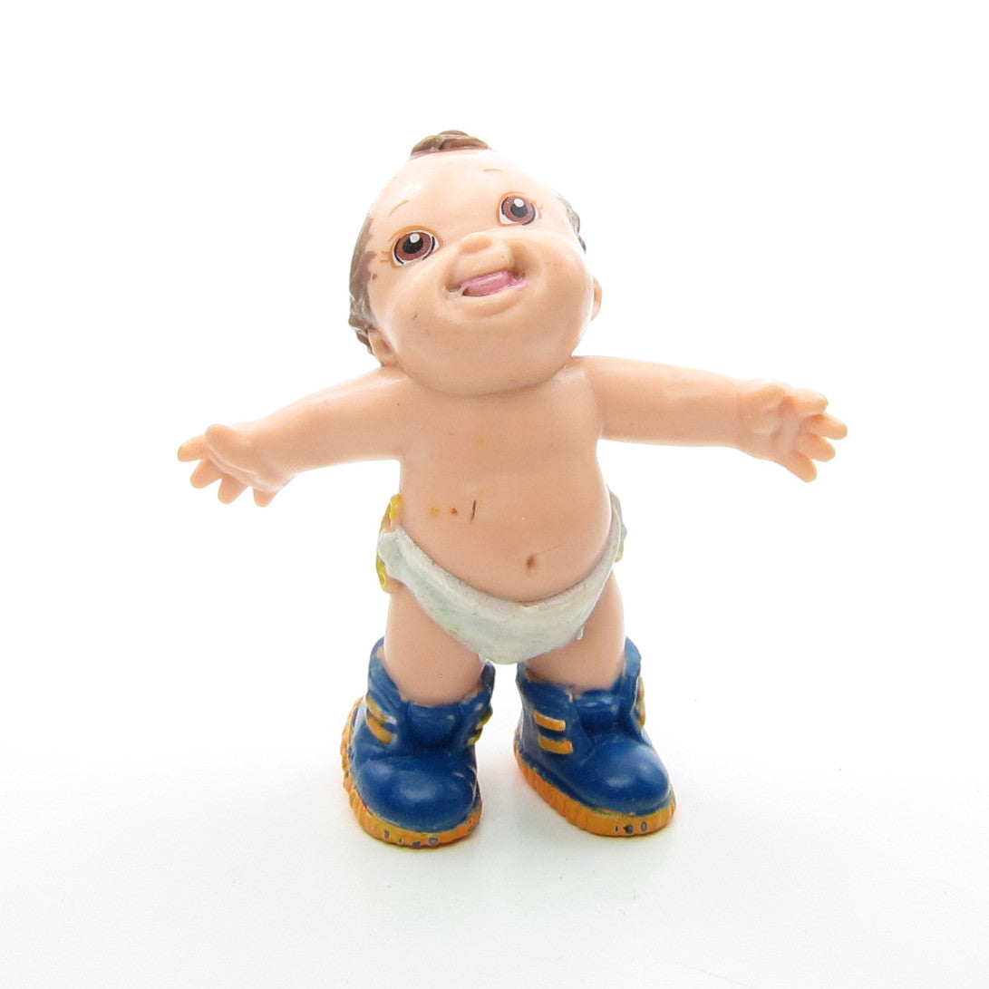 Magic Diapers Baby figurine wearing blue sneakers