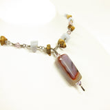 An agate pendant makes a stunning focal point on this mineral chip necklace.