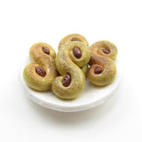 Miniature polymer clay lussekatter or saffron buns for Saint Lucia's Day