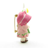 Girl in pink dress and bonnet with daisy vintage Hallmark pin