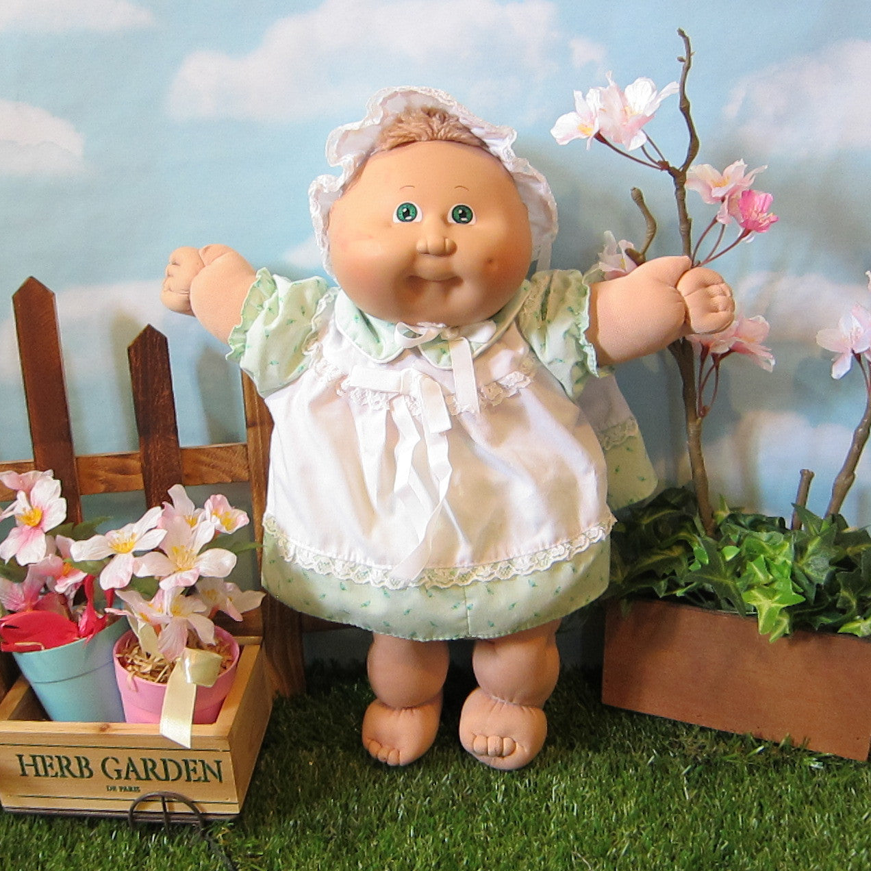 Cabbage Patch Kids Preemie girl doll with light brown hair, green eyes, dimple