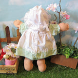Cabbage Patch Kids Preemie girl doll with white bonnet, green dress