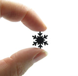 Small 1/2-inch diameter paper punched snowflakes