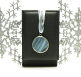 Pale blue winter solstice moon stained glass pendant