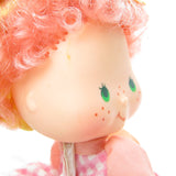 Peach Blush Strawberry Shortcake doll with orange mark on face