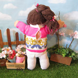 Cabbage Patch Kids doll with dark brown hair, teddy bear sweater outfit