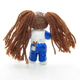 Cabbage Patch Kids miniature figurine with brown yarn hair and I Love You t-shirt